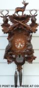 A c1980 Black Forest Cuckoo clock with hunting design, pheasant and hare decoration,