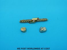 A 15ct gold brooch with a seed pearl and two gold teeth (7.