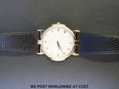 Gucci 3400M gold plated wristwatch with gold hands and Roman numerals, on black leather strap,