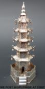 A Chinese white metal temple with bells to roof corners,