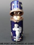 A late 18th / 19thC Limoges enamel scent bottle decorated with an infant smelling roses