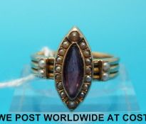 A Victorian ring made up of three bands marked 18ct gold set with a marquise cut garnet surrounded