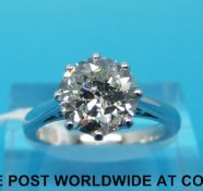 An 18ct white gold ring set with a round brilliant cut diamond measuring approximately 2.