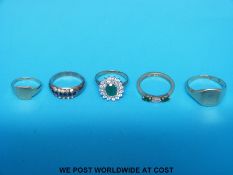 Five 9ct gold rings to include two signet, one emerald and paste etc.