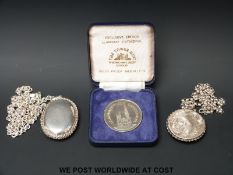 A hallmarked silver locket and a white metal example stamped 925 together with a cased proof