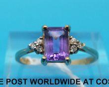 A 9ct gold ring set with an emerald cut amethyst and diamonds (size P)