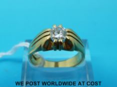 An 18ct gold ring set with a round brilliant cut diamond of approximately 0.