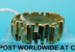 A yellow metal ring with a bark effect textured finish marked 22ct gold (size M, 5.