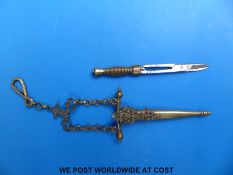 A pair of novelty scissors formed as a sword on chatelaine type mount