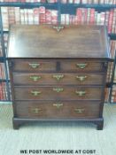 A George III mahogany bureau, the fall flap opening to reveal fitted interior with drawers,