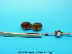 A pair of 9ct gold earrings set with pressed amber,