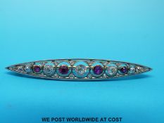 A platinum and gold brooch set with alternating diamonds and rubies,