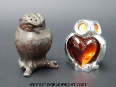 A novelty late 19thC / early 20thC pewter or similar pepperette formed as an owl together with a