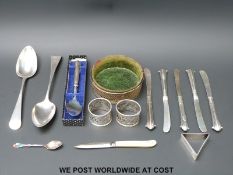 Two hallmarked silver table spoons, three hallmarked silver napkin rings,
