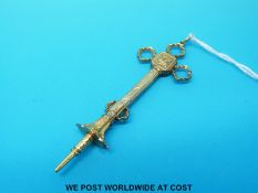 A yellow metal ornate crucifix propelling pencil