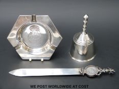 A white metal letter opener with inscription 