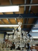 A brass and cut glass chandelier fitted for electricity