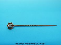 A yellow metal stick pin set with an old cut diamond