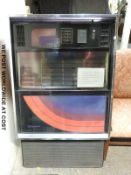 A Seeburg floor standing juke box late c1970/early 1980 with red maroon and blue graphics to glass