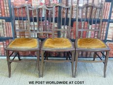 Three late 19thC bedroom chairs with inlaid decoration together with a spare back