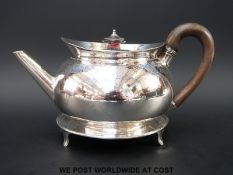 A Georgian hallmarked silver teapot on stand, with bright cut decoration in the neoclassical style.