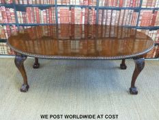 A Victorian mahogany oval table with extra leaf and baize covering raised on cabriole legs,