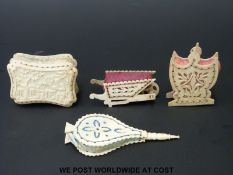 Four 19thC carved and pierced bone pin cushions including a Chinese garden scene, wheelbarrow,