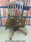 A vintage oak office swivel chair