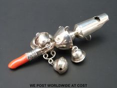 A Georgian hallmarked silver coral handled babies rattle with bells and whistle,