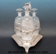 A Regency three bottle silver plated decanter set on stand (height 26cm)