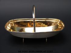 A George V hallmarked silver novelty sweetmeat or bon bon dish formed as a trug with gilt wash