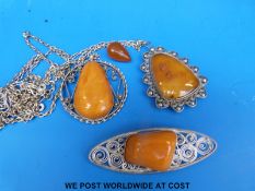 Two white metal pedants,