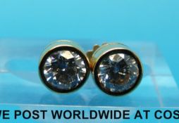 A pair of 18ct gold stud earrings, each set with a round brilliant cut diamond of approximately 0.