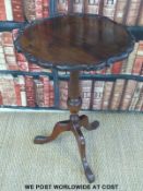 A mahogany tilt top circular table with moulded rim raised on a tripod base (H77 x D49cm)