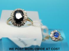 An 18ct gold ring set with an oval sapphire surrounded by diamonds and a yellow metal ring marked