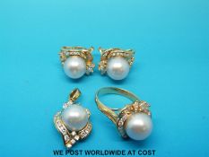 An 18ct gold pendant set with a large pearl surrounded by marquise and round brilliant cut diamonds,
