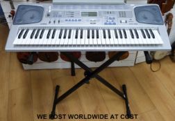 A Casio CTK-591 five octave electronic keyboard, complete with stand,