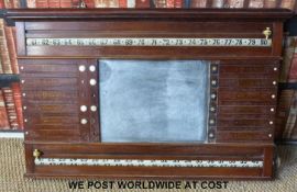 A vintage snooker scoreboard with lamp above, marked Palmer & Sons,