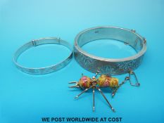 A brooch set with two Venetian glass beads in the form of a bee together with two hallmarked silver