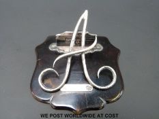 A hallmarked silver paper clip in the form of an A on tortoiseshell mount