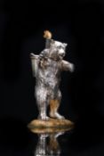 A Victorian novelty hallmarked silver table lighter formed as a bear with torch in one paw and