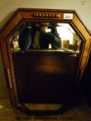 Two oak framed bevelled glass mirrors,