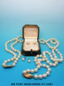 A single strand of pearls with a yellow metal clasp marked 585 another single strand of pearls with