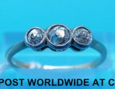 A yellow metal ring set with three diamonds (size O)