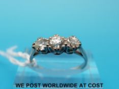 A platinum ring set with three diamonds, the centre stone measuring approximately 0.