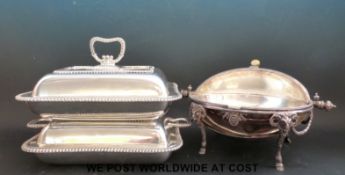 A silver plated warming dish and two entree dishes
