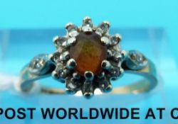 A 9ct gold set with a citrine surrounded by diamonds (size J)