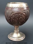 A George III hallmarked silver mounted carved coconut cup, Ldn 1787,