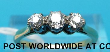 A yellow metal ring marked 18ct set with three round brilliant cut diamonds (size N)