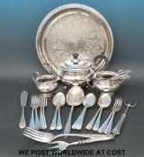 A silver plated tea set on tray together with a collection of plated cutlery,